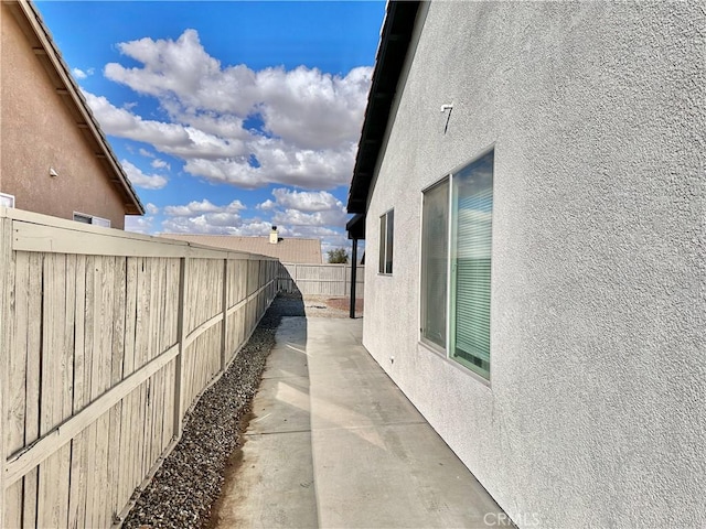 view of side of property with a patio