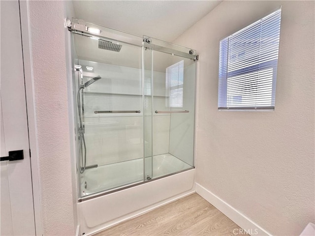 bathroom featuring shower / bath combination with glass door and hardwood / wood-style flooring