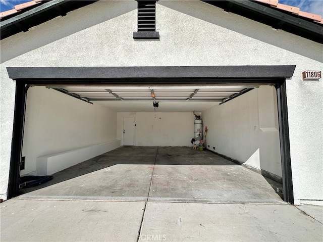 garage with secured water heater and a garage door opener