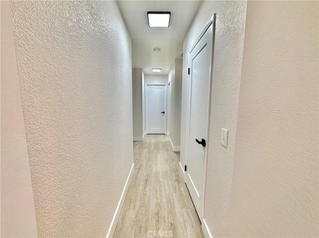 corridor with light wood-type flooring