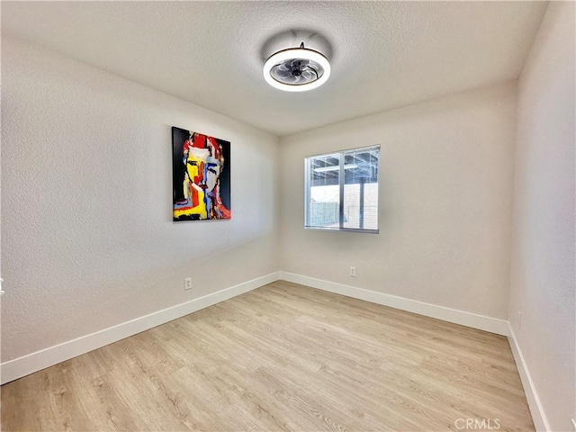 spare room with wood-type flooring and a textured ceiling