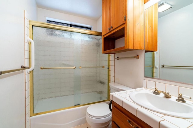 full bathroom featuring vanity, toilet, and enclosed tub / shower combo