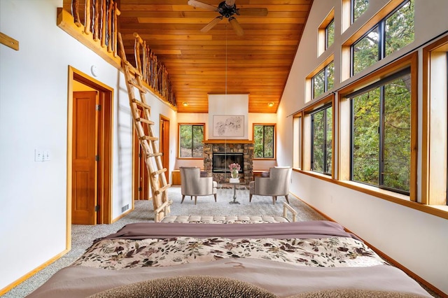 unfurnished sunroom featuring ceiling fan, a fireplace, a healthy amount of sunlight, and vaulted ceiling