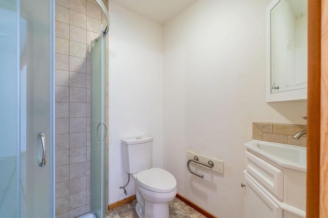 bathroom with vanity, an enclosed shower, and toilet