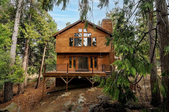 rear view of property with a wooden deck