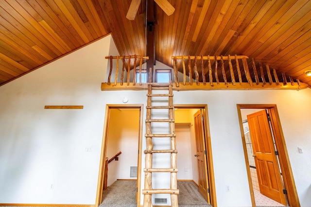 interior space with ceiling fan, wooden ceiling, carpet floors, and high vaulted ceiling