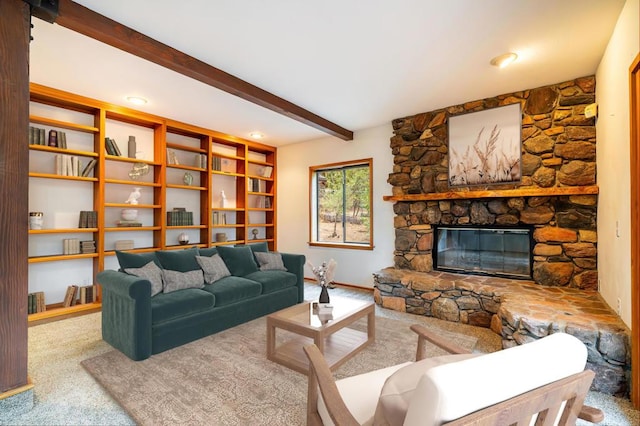 carpeted living room featuring a stone fireplace and beamed ceiling