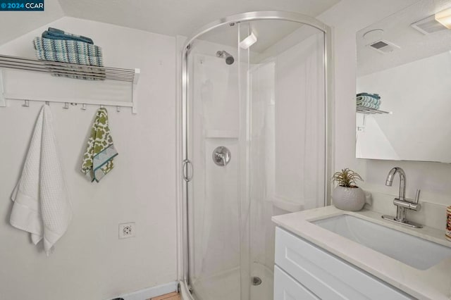 bathroom with vanity and an enclosed shower