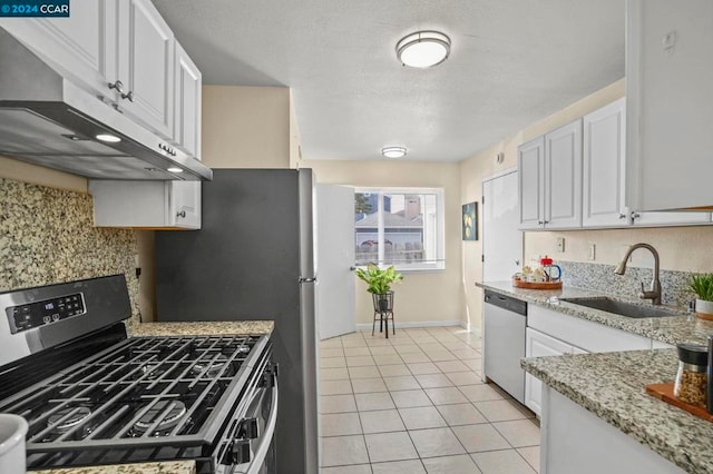 kitchen featuring light stone countertops, appliances with stainless steel finishes, white cabinetry, and sink