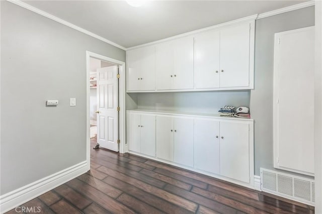 interior space featuring crown molding, white cabinets, and dark hardwood / wood-style floors