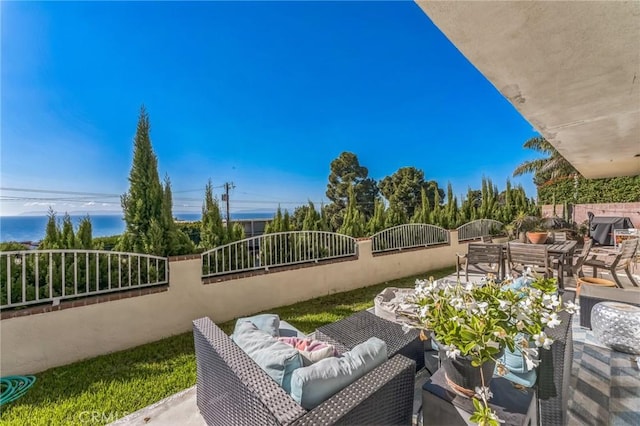 balcony featuring a water view and a patio