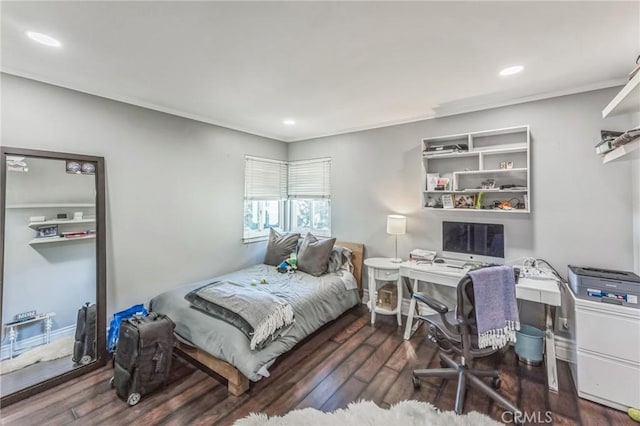 bedroom with dark hardwood / wood-style flooring and ornamental molding