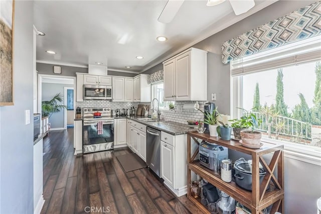 kitchen featuring stainless steel appliances, white cabinetry, and plenty of natural light