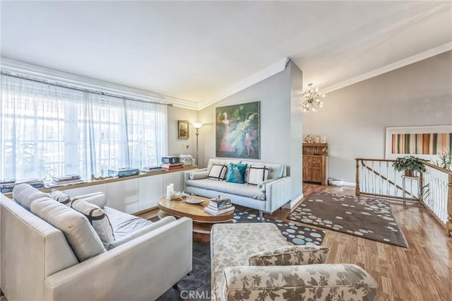 living room featuring ornamental molding, lofted ceiling, and hardwood / wood-style flooring