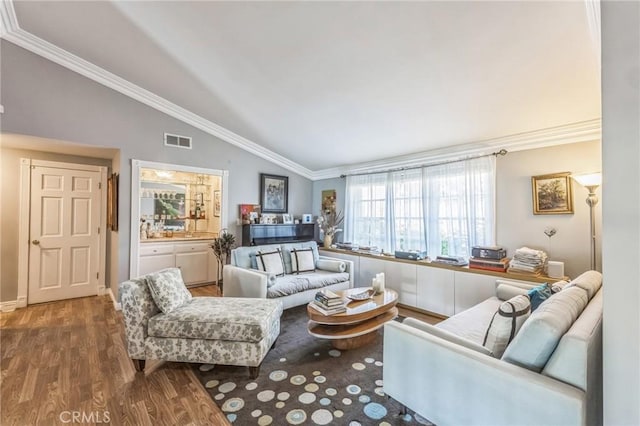 living room with crown molding, wood-type flooring, and vaulted ceiling