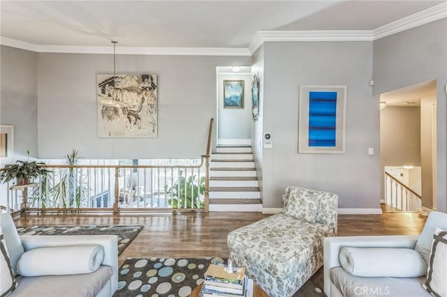 living room with hardwood / wood-style flooring and crown molding