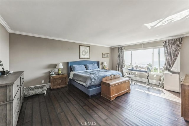 bedroom featuring crown molding and dark wood-type flooring