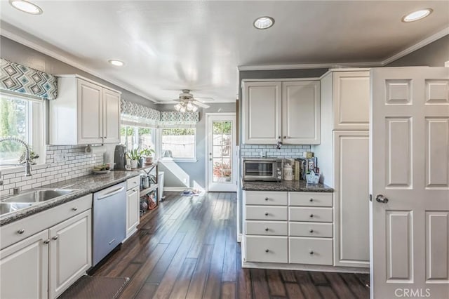 kitchen featuring a wealth of natural light, white cabinetry, and dishwasher