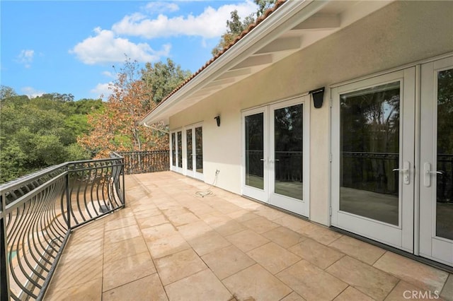 view of patio / terrace featuring french doors and a balcony