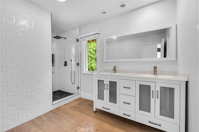 bathroom with vanity, an enclosed shower, and hardwood / wood-style flooring