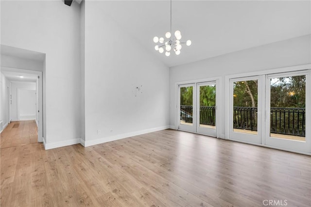 interior space featuring light hardwood / wood-style flooring, high vaulted ceiling, and a notable chandelier