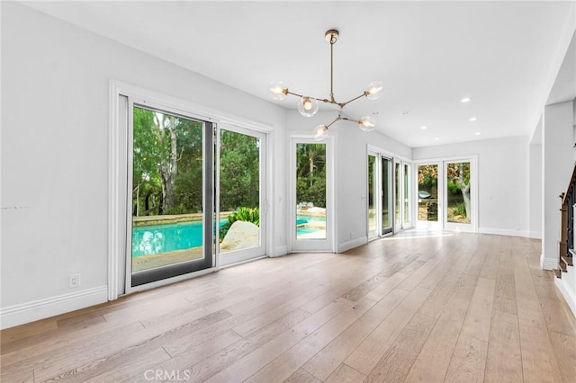 interior space featuring light hardwood / wood-style floors and a chandelier