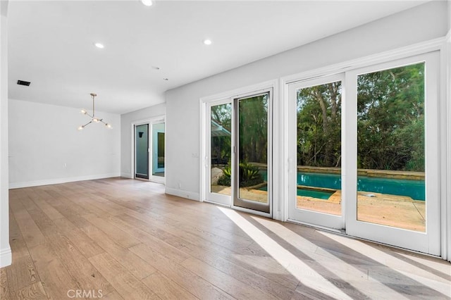 interior space featuring light hardwood / wood-style flooring and an inviting chandelier