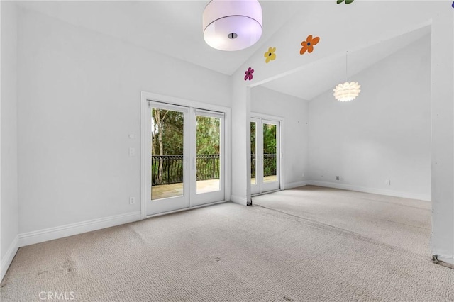 unfurnished room with carpet and high vaulted ceiling