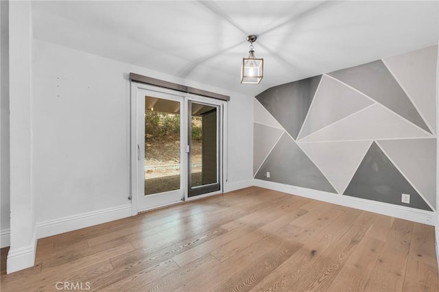 spare room with wood-type flooring