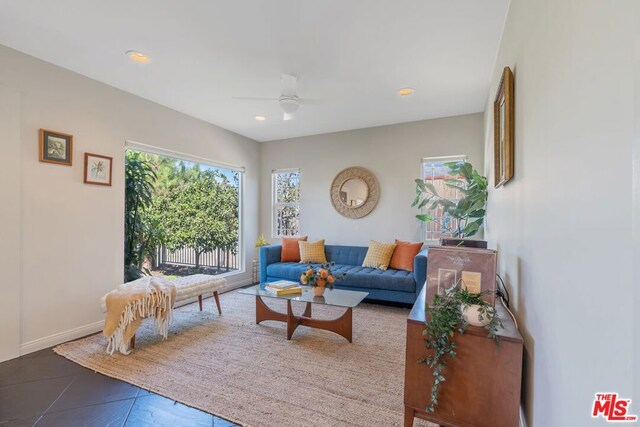 tiled living room featuring ceiling fan