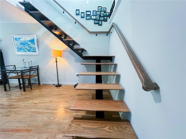 stairway featuring hardwood / wood-style floors