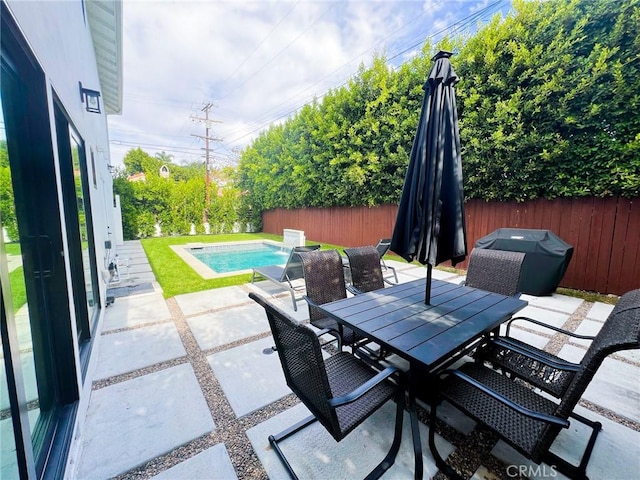 view of patio / terrace with a fenced in pool