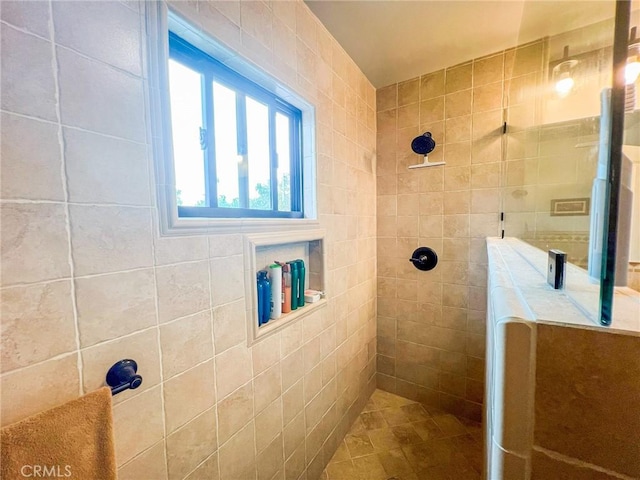 bathroom with a tile shower