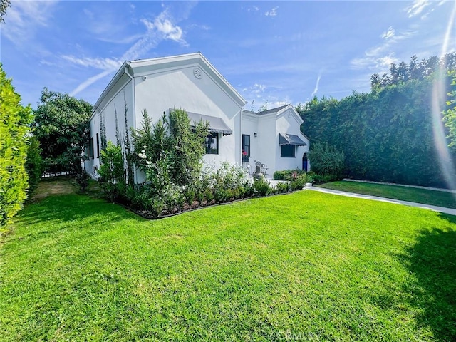 view of property exterior featuring a yard