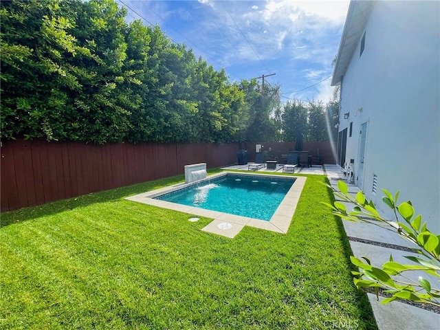 view of pool featuring a lawn