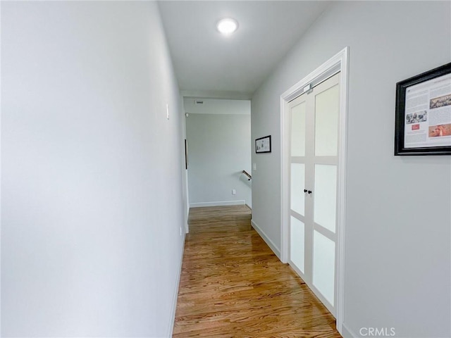 hallway with light wood-type flooring