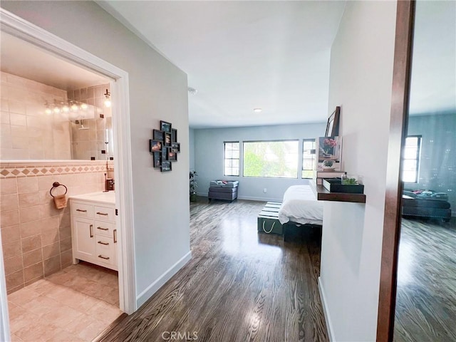 hall featuring wood-type flooring and tile walls