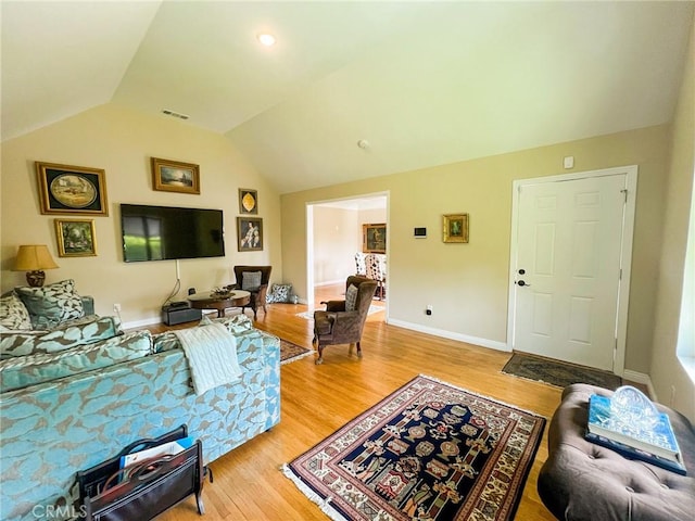 living room featuring light hardwood / wood-style floors and lofted ceiling