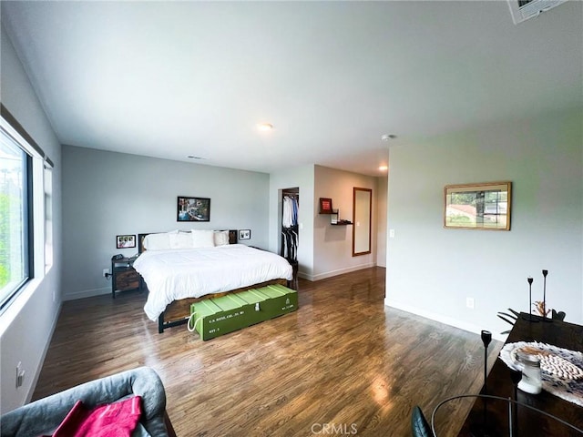 bedroom with dark hardwood / wood-style flooring