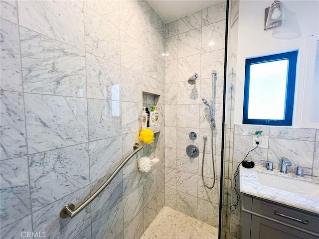 bathroom featuring vanity and tiled shower