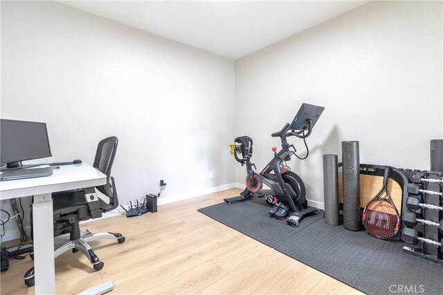 home office with light hardwood / wood-style flooring