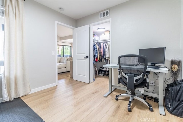 office with light hardwood / wood-style flooring