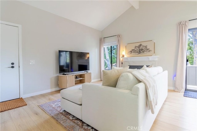 living room with beam ceiling, high vaulted ceiling, and light hardwood / wood-style flooring