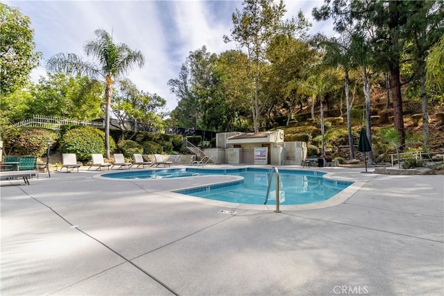 view of swimming pool with an outdoor kitchen and a patio area