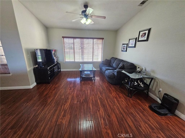 living room featuring baseboards, visible vents, lofted ceiling, ceiling fan, and wood finished floors