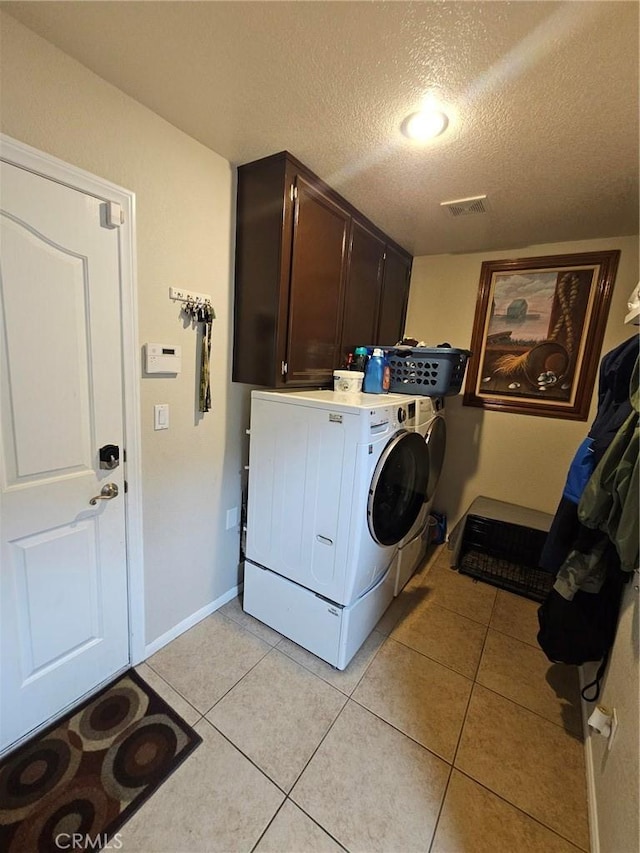 laundry room with cabinet space, visible vents, light tile patterned flooring, and independent washer and dryer