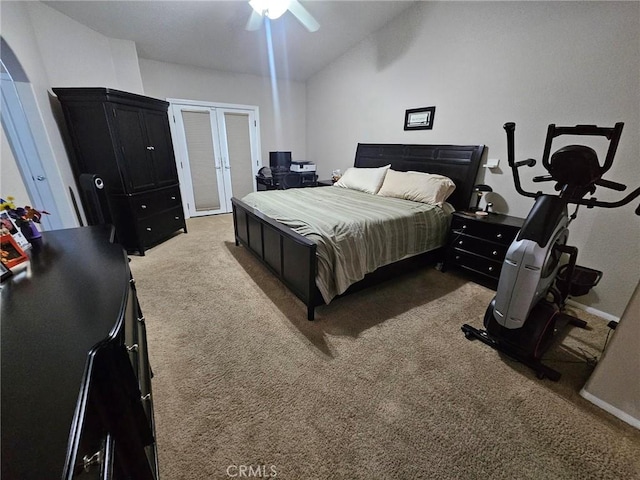 bedroom with ceiling fan, arched walkways, carpet floors, vaulted ceiling, and french doors