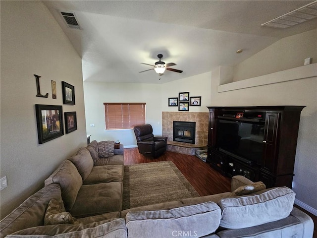 living room with ceiling fan, visible vents, wood finished floors, and a tile fireplace