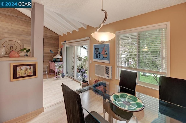 dining space with vaulted ceiling with beams, light hardwood / wood-style floors, and wooden walls