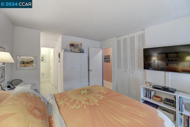 bedroom featuring a closet and a textured ceiling